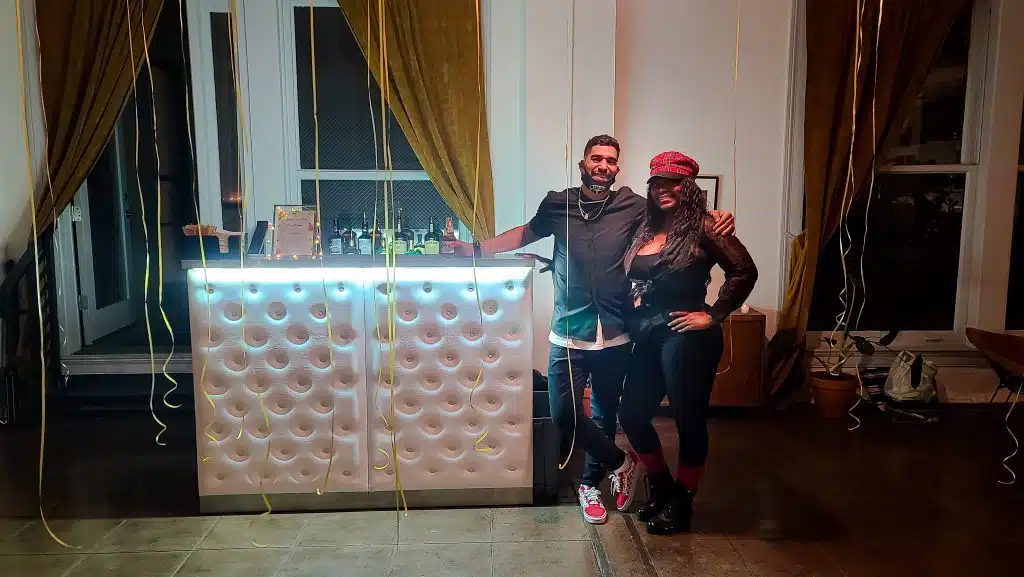 Luxurious white bar with LED light. Bartender with guest taking a picture | Party Shakers LA